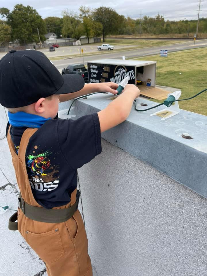 Community Spirit — kid helping install on rooftop